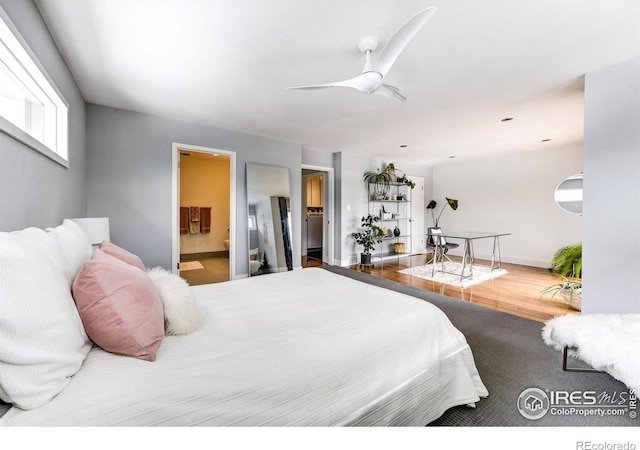 bedroom featuring ensuite bath, wood finished floors, and ceiling fan