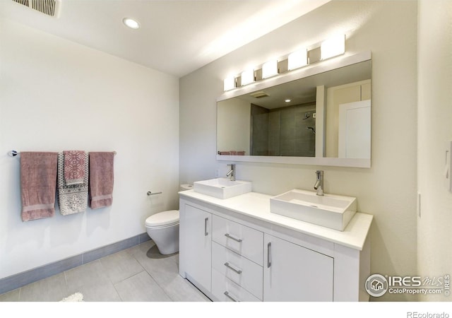 bathroom featuring tile patterned floors, visible vents, a shower stall, and a sink