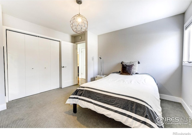 bedroom featuring light carpet, baseboards, and a closet