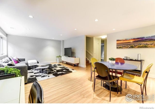 dining room featuring recessed lighting, stairway, baseboards, and light wood-style floors