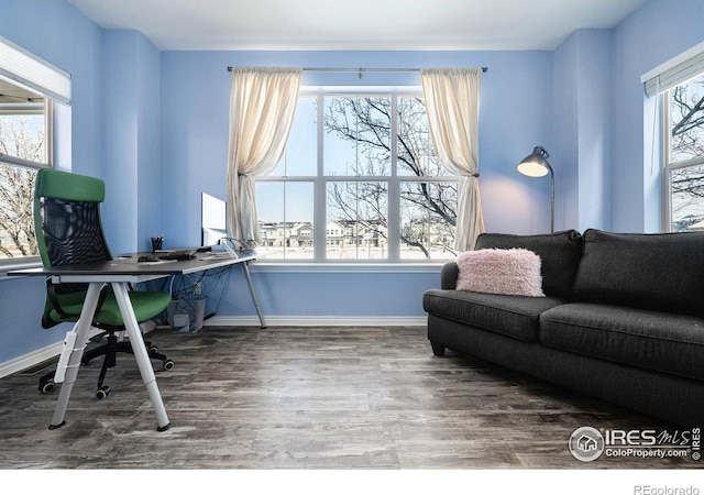 office space featuring baseboards and wood finished floors