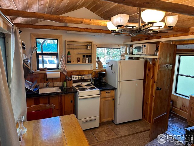 kitchen featuring white appliances, lofted ceiling with beams, wooden ceiling, a sink, and a notable chandelier