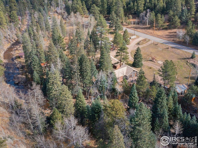 birds eye view of property with a forest view