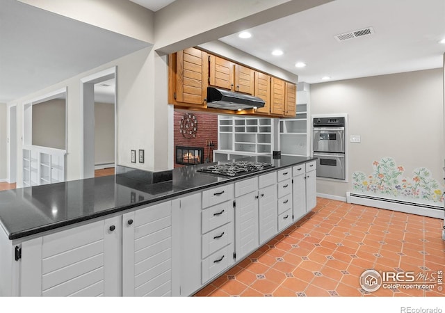 kitchen with visible vents, dark countertops, stainless steel appliances, under cabinet range hood, and a baseboard heating unit