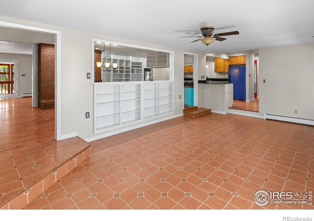 unfurnished living room featuring ceiling fan with notable chandelier, a baseboard radiator, and baseboards