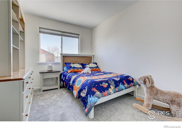 carpeted bedroom featuring baseboards