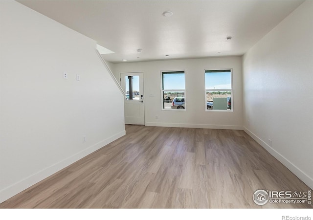 3282 Crusader St, Fort Collins, CO 80524 - unfurnished living room with baseboards and light wood finished floors