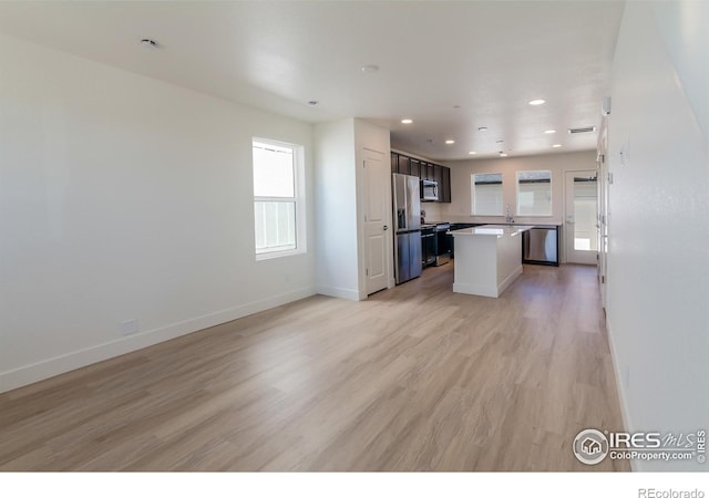 3282 Crusader St, Fort Collins, CO 80524 - kitchen with appliances with stainless steel finishes, light wood-style flooring, baseboards, open floor plan, and recessed lighting