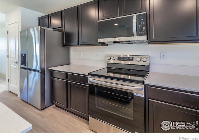 3282 Crusader St, Fort Collins, CO 80524 - kitchen featuring stainless steel appliances, light wood finished floors, and light countertops