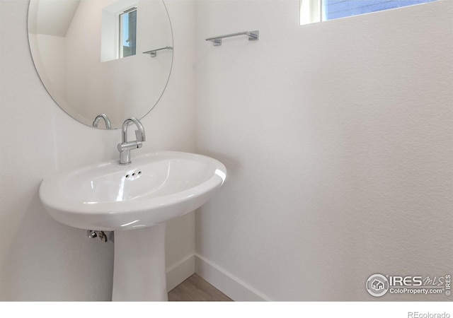 3282 Crusader St, Fort Collins, CO 80524 - bathroom featuring baseboards and a sink