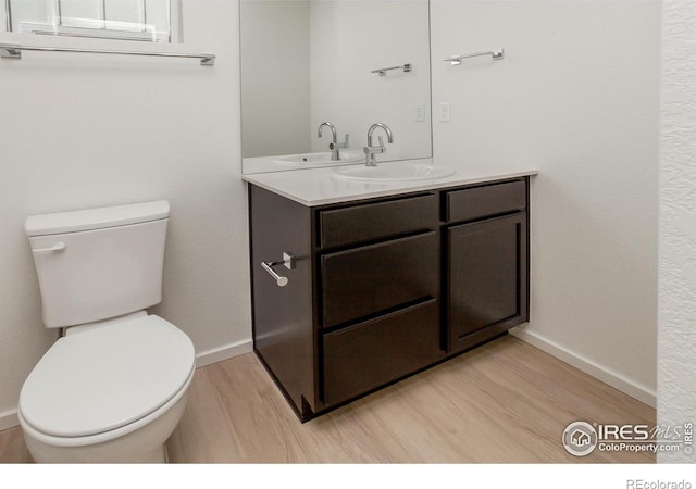 3282 Crusader St, Fort Collins, CO 80524 - bathroom featuring wood finished floors, vanity, toilet, and baseboards