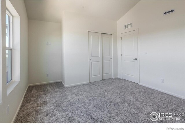3282 Crusader St, Fort Collins, CO 80524 - unfurnished bedroom featuring carpet, baseboards, vaulted ceiling, and a closet
