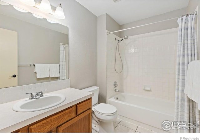 full bathroom featuring shower / bath combo, vanity, toilet, and tile patterned floors