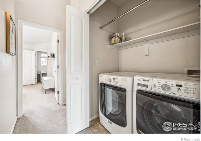 laundry room featuring laundry area, baseboards, washer and dryer, and light colored carpet