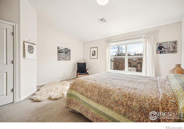 bedroom with baseboards, visible vents, vaulted ceiling, and carpet flooring