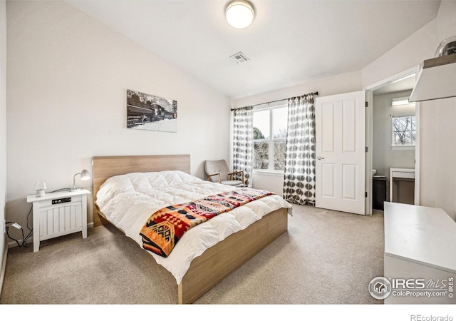 bedroom with light carpet, vaulted ceiling, visible vents, and multiple windows