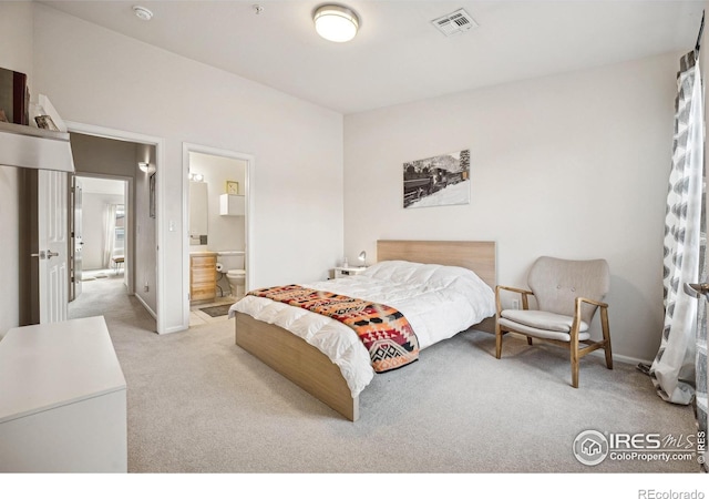 bedroom featuring light carpet, connected bathroom, visible vents, and baseboards