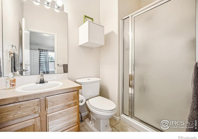 full bathroom featuring toilet, a stall shower, vanity, and tile patterned floors