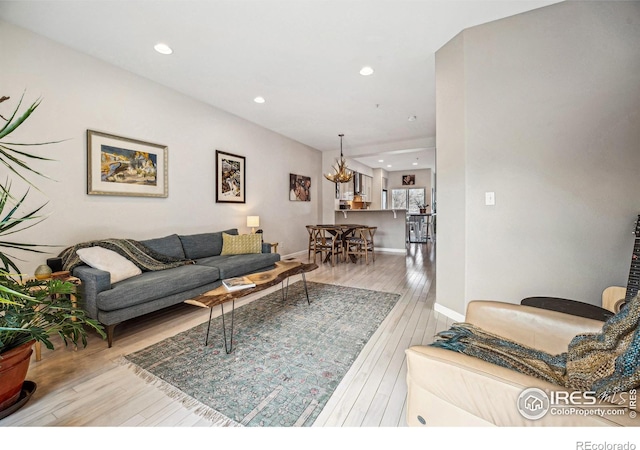 living area featuring hardwood / wood-style flooring, baseboards, and recessed lighting