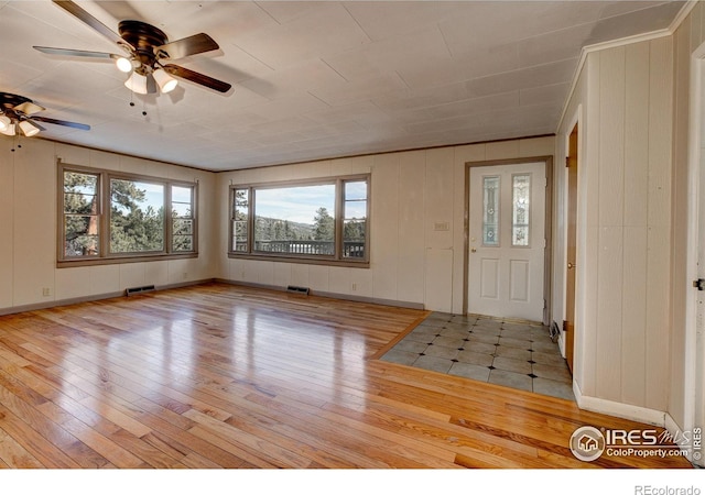 entryway featuring visible vents, ceiling fan, and hardwood / wood-style flooring