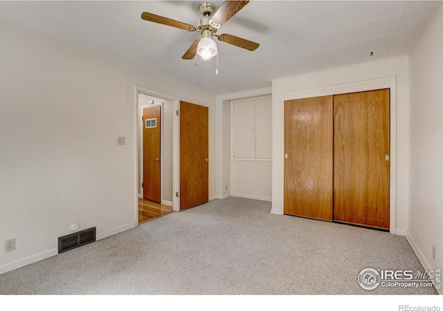 unfurnished bedroom with visible vents, baseboards, ceiling fan, carpet, and a closet