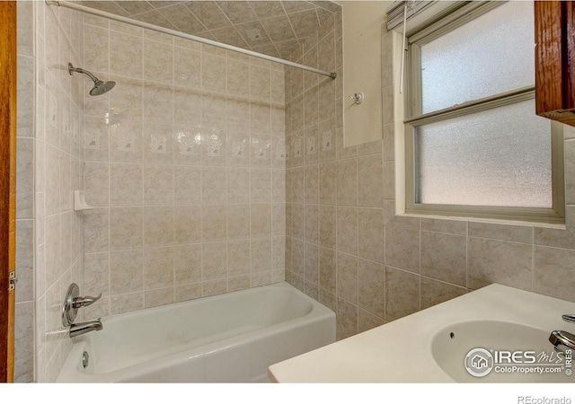 bathroom with a sink and bathing tub / shower combination