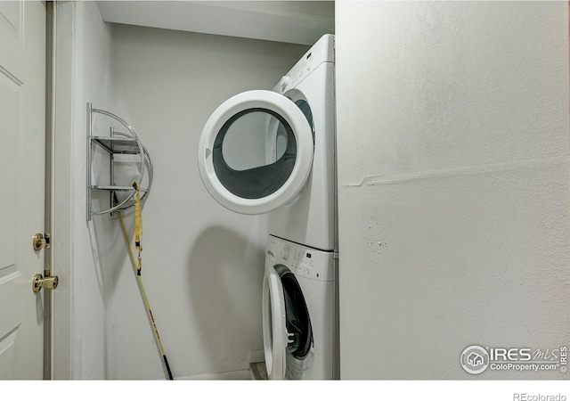 laundry area with stacked washer and clothes dryer and laundry area