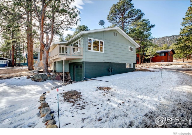 exterior space with stairway and a wooden deck