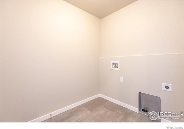 laundry room with laundry area, baseboards, washer hookup, and electric dryer hookup