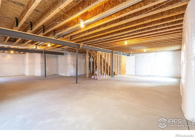 unfinished basement featuring water heater