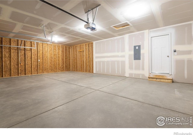 garage featuring electric panel and a garage door opener