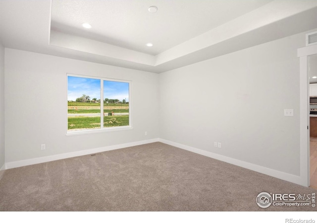 6997 Feather Reed Dr, Wellington, CO 80549 - carpeted empty room with baseboards, a raised ceiling, and recessed lighting
