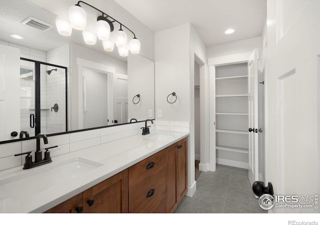 6997 Feather Reed Dr, Wellington, CO 80549 - full bath featuring a stall shower, double vanity, a walk in closet, tile patterned floors, and baseboards