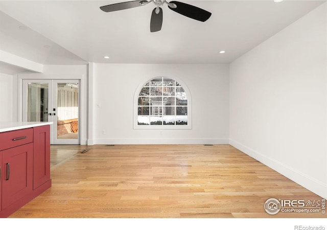 empty room featuring french doors, light wood-type flooring, recessed lighting, and baseboards