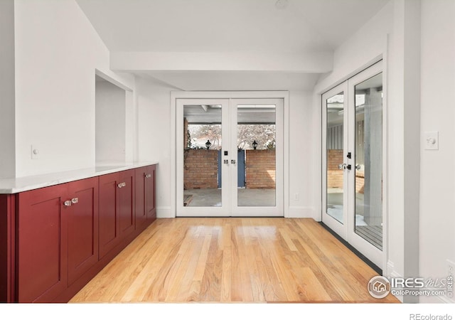 doorway to outside with light wood-type flooring, french doors, and baseboards