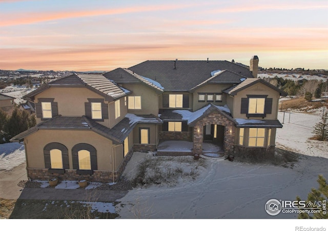 view of front of home with stone siding and stucco siding