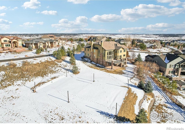 snowy aerial view with a residential view