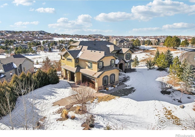 snowy aerial view featuring a residential view