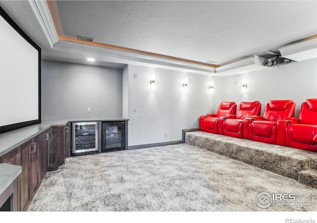 carpeted home theater room featuring a dry bar, beverage cooler, visible vents, and a raised ceiling