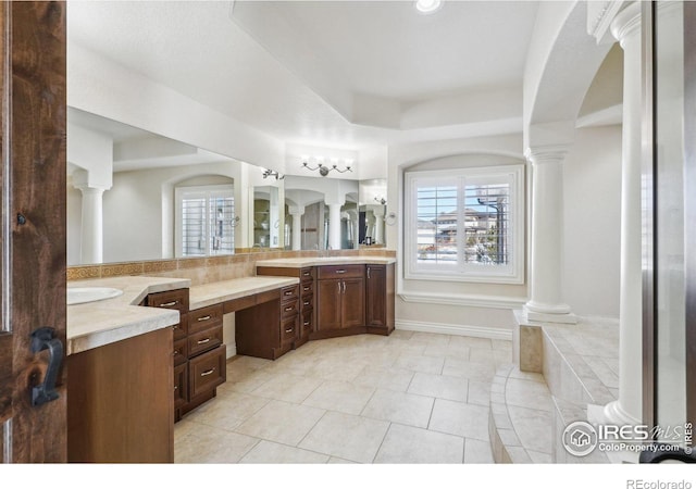 full bathroom with tile patterned floors, vanity, and ornate columns