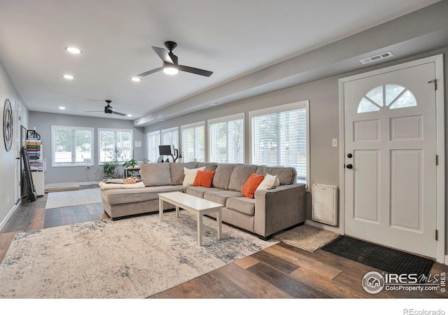 living area featuring baseboards, wood finished floors, visible vents, and recessed lighting