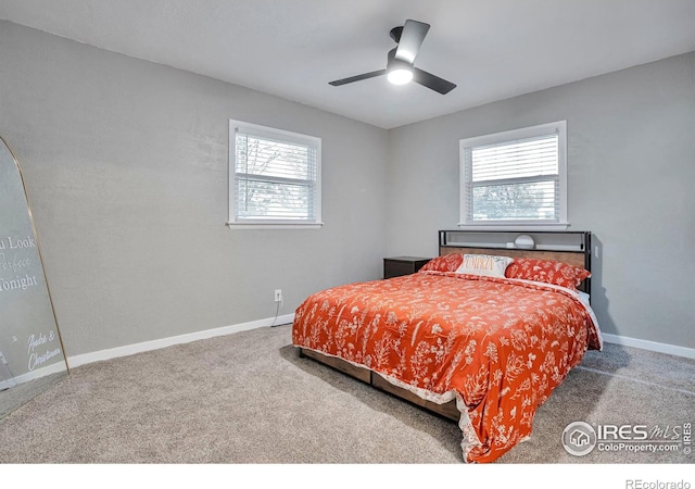 carpeted bedroom with a ceiling fan and baseboards