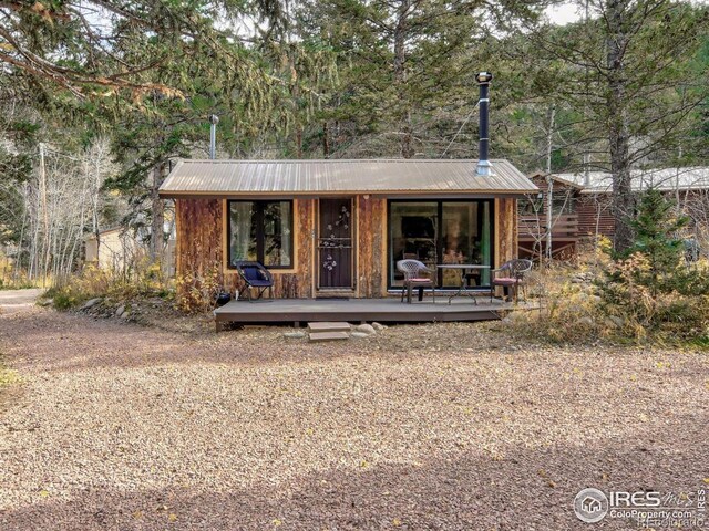 rustic home with metal roof and an outdoor structure