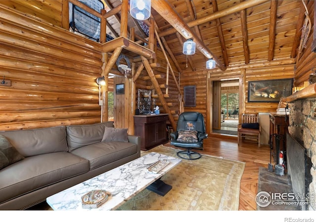 living area featuring wood ceiling, rustic walls, and high vaulted ceiling