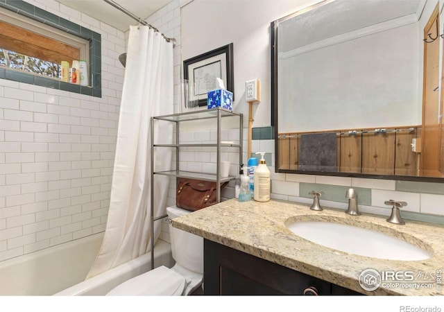 full bathroom featuring backsplash, toilet, vanity, and shower / bath combo