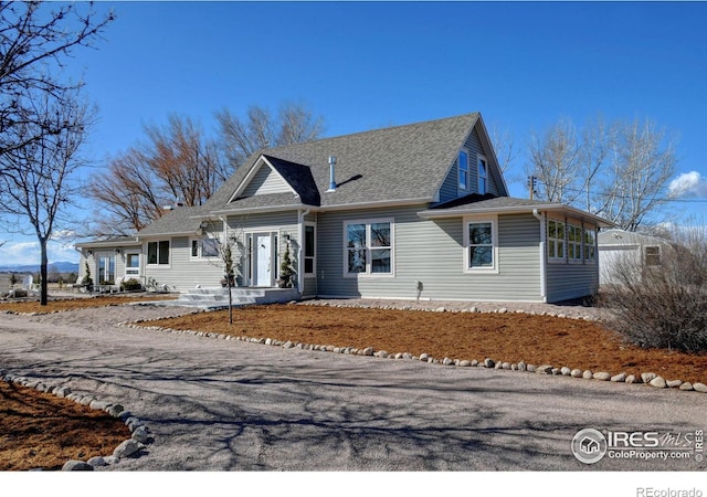 view of front of home featuring roof with shingles