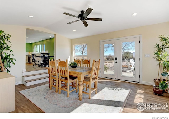 dining room with baseboards, french doors, wood finished floors, and recessed lighting