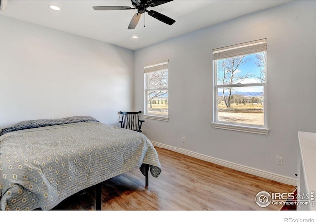 bedroom with a ceiling fan, baseboards, wood finished floors, and recessed lighting