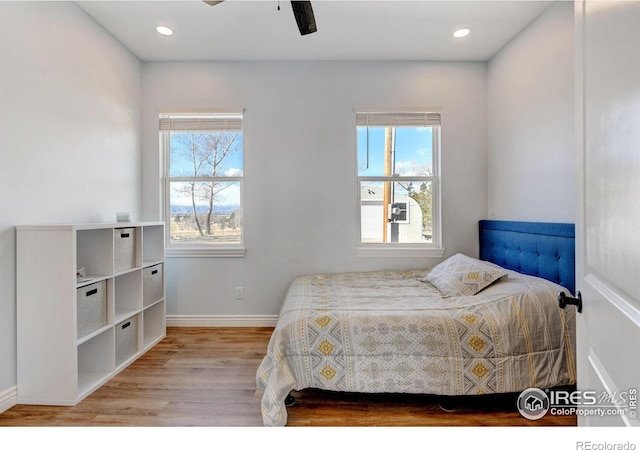 bedroom with recessed lighting, wood finished floors, a ceiling fan, and baseboards