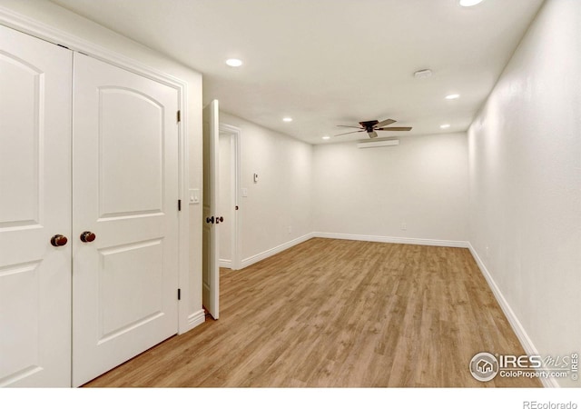 spare room with a ceiling fan, recessed lighting, light wood-style flooring, and baseboards